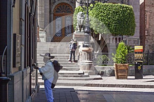 Panoramic view of a downtown street of Guanajuato with a mariachi singing