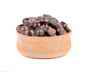 Guarana seed in wooden bowl, isolated on white background. Dietary supplement guarana, caffeine cource for energy drinks