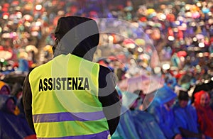 Guard with the phosphorescent vest at the concert and the text A photo