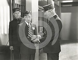 Guard removing handcuffs from prisoner