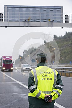 Guardia Civil officer next to a speed control monitors traffic