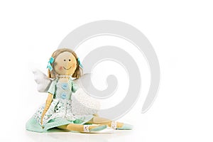 Guardian angel: isolated handmade doll with a white heart in her