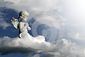 Guardian angel kneeling and praying. Angel guardian on the cloud