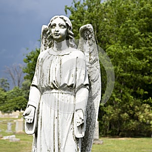 Guardian angel statue in graveyard.