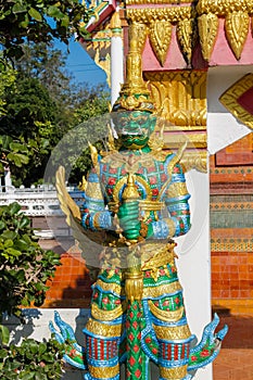 Guardian of the Buddha nio or dvarapala standing at the entrance of Buddhist temple in Thailand wat photo