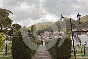 Guatavita colombian town summer scene with pine peatonal street, gardens and mountains photo
