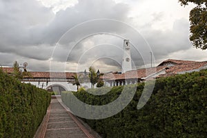 Guatavita town public gardens view with a pine wall near to a peatonal path and downtown photo