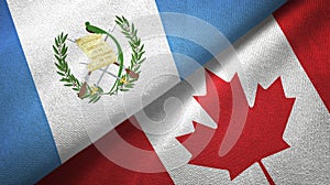 Guatemala and Canada two flags textile cloth, fabric texture photo