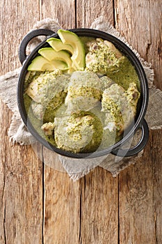 Guatemalan Green Chicken Stew is more commonly known as chicken stew with tomatillos close up in the plate. Vertical top view