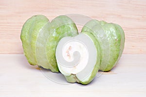 Guava fruit and half piece isolated on wood background