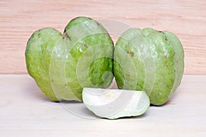 Guava fruit and half piece on wood background