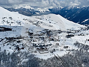 Gudauri Village Panorama With Ski Resort Background From Aerial Perspective. Aerial drone view of Gudauri ski resort in winter.