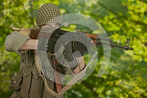 guerilla fighter firing AK 47 photo