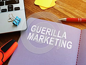 Guerilla marketing guide and laptop.