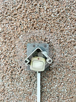 A guest doorbell on a concrete wall