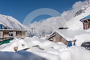 Guest houses in the Village Kyangjin Gompa covered by snow