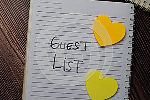 Guest List write on a book with keywords isolated wooden table