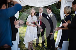 Guests clapping for newly married couple