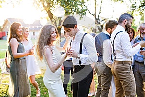 Guests dancing at wedding reception outside in the backyard.