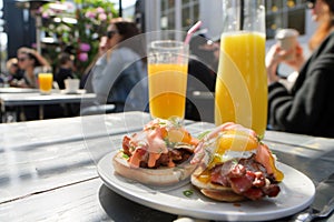 guests at sidewalk caf with eggs benedict, orange juice