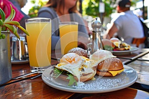 guests at sidewalk caf with eggs benedict, orange juice