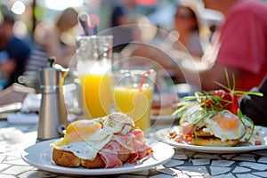 guests at sidewalk caf with eggs benedict, orange juice