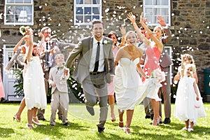 Guests Throwing Confetti Over Bride And Groom