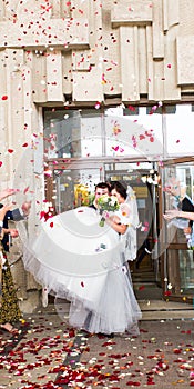 Guests Throwing Confetti Over Bride And Groom At Wedding