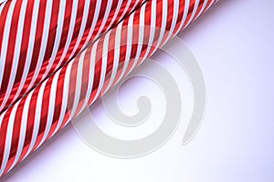 Guft wrapping paper with red and white stripes on white background with copy space for present packing. photo