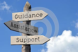 Guidance, assistance, support - wooden signpost with three arrows