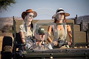 Guide drives two female guests in jeep