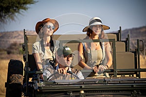 Guide driving two female guests in jeep