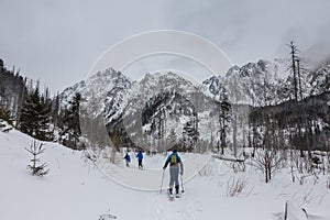 Guide and two backcountry skitourers in snowy High Tatras, the mountain range and national park in Slovakia