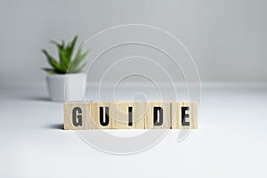 Guide Word Written In Wooden Cube on white background