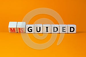 Guided or misguided symbol. Turned wooden cubes and changed the word misguided to guided. Beautiful orange table, orange