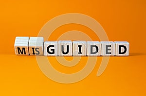 Guided or misguided symbol. Turned wooden cubes and changed the word misguided to guided. Beautiful orange table, orange