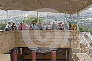 People on guided tour of the palace of Knossos, Crete