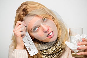 Guidelines for treating cold. Girl tablet in mouth drink water. Headache and cold remedies. Woman tousled hair scarf