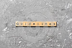 Guidelines word written on wood block. Guidelines text on table, concept