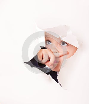 Guilty looking kid in a hole in white paper