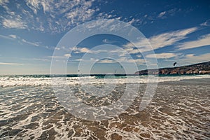 Guincho beach sea with surfers doing kitesurf