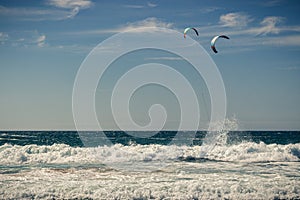 Guincho beach sea with surfers doing kitesurf