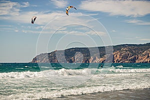 Guincho beach sea with surfers doing kitesurf