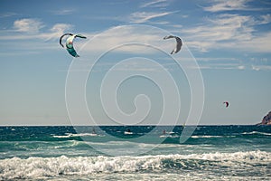 Guincho beach sea with surfers doing kitesurf