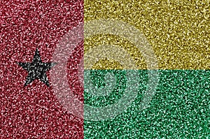 Guinea Bissau flag depicted on many small shiny sequins. Colorful festival background for party