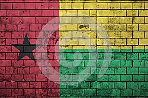 Guinea Bissau flag is painted onto an old brick wall