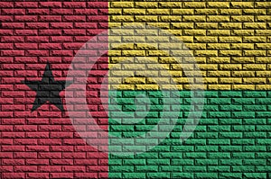 Guinea Bissau flag is painted onto an old brick wall