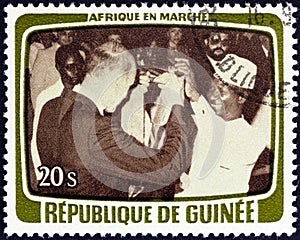 GUINEA - CIRCA 1979: A stamp printed in Guinea shows Toasting the agreement, circa 1979.