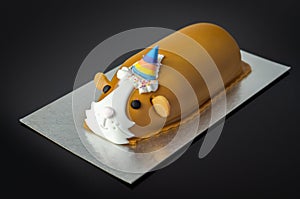 Guinea pig cake, soft madeira sponge layered with fruity raspberry jam and frosting finished with sweet edible decorations