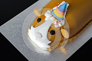 Guinea pig cake, soft madeira sponge layered with fruity raspberry jam and frosting finished with sweet edible decorations